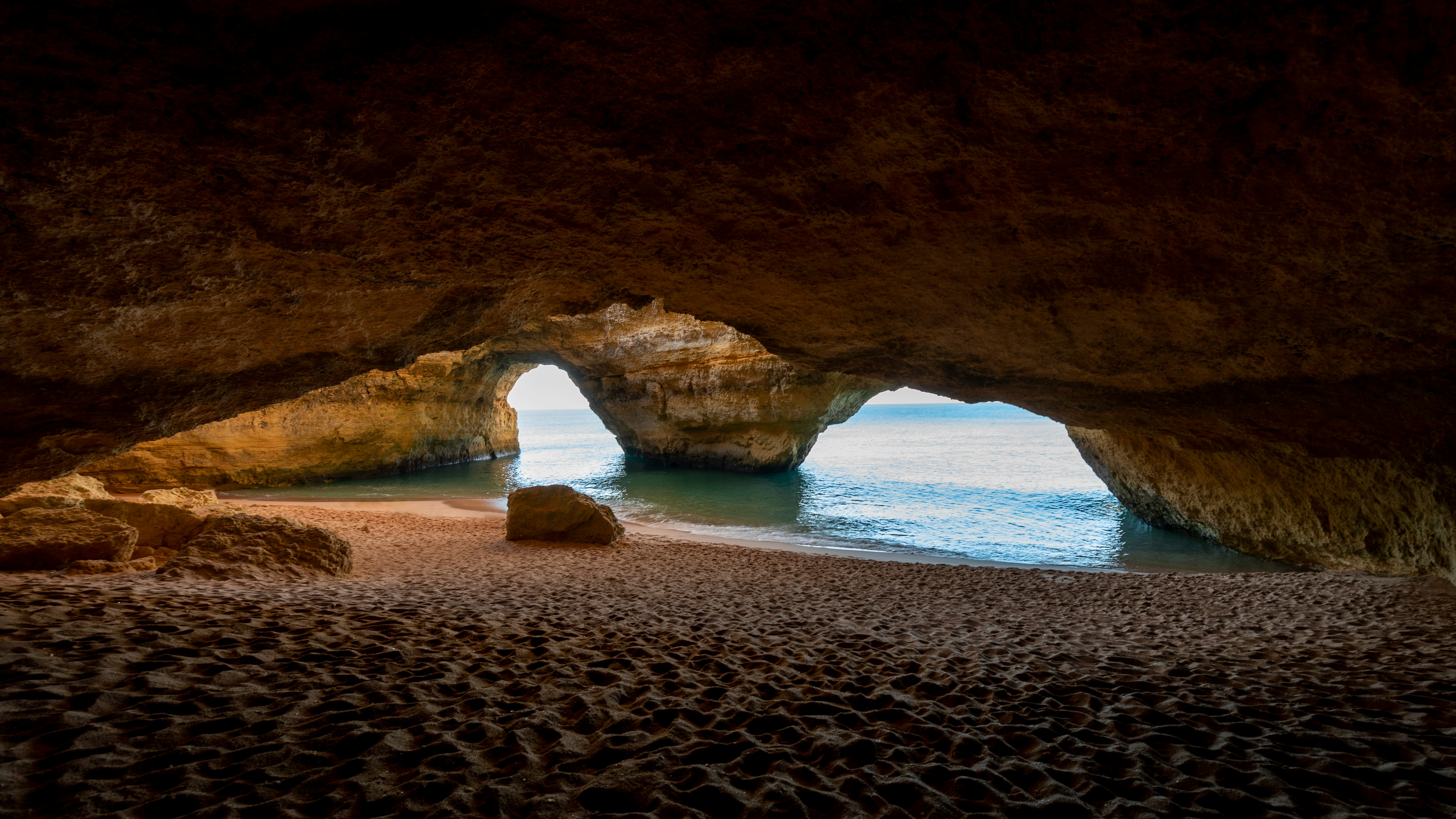 brown rock formation on beach during daytime